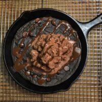 Four healthy pizookie recipes that all pack more than 50 grams of protein. Flavors include s'mores, Twix, triple chocolate, and red velvet, all topped with ice cream.