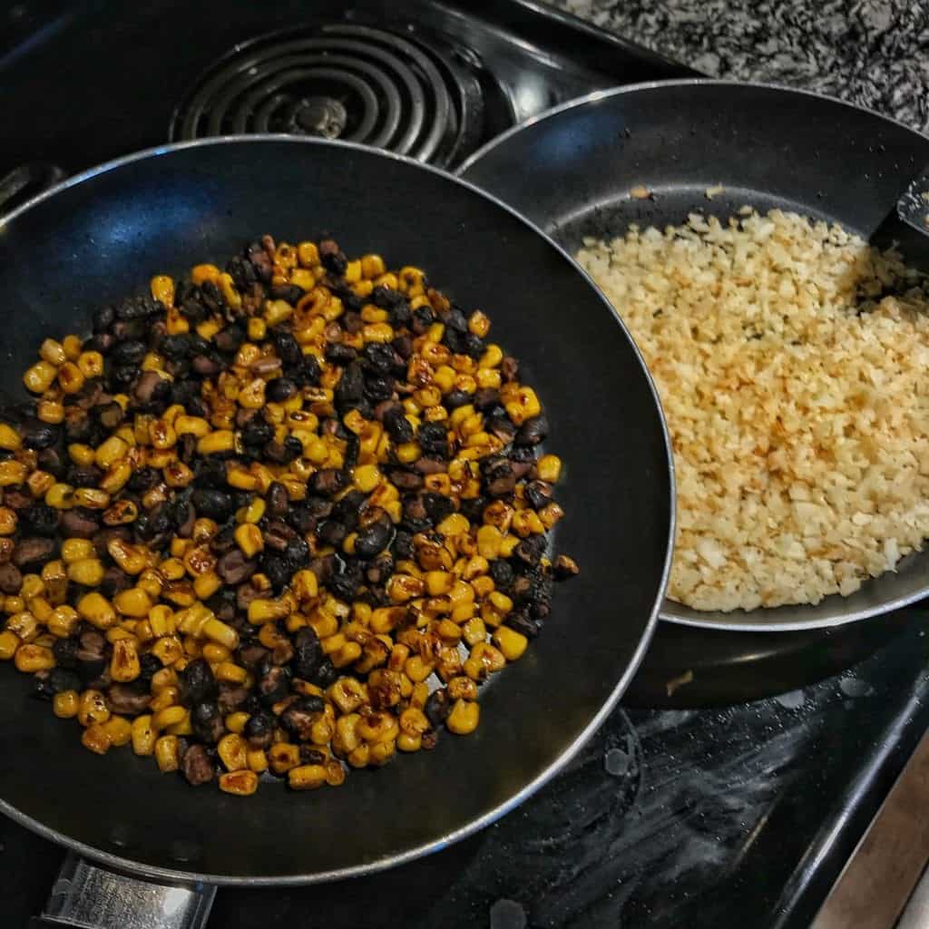 Super simple recipes for pan roasted corn and black beans as well as cilantro lime cauliflower rice to pair with crispy carnitas for delicious high protein, low calorie burrito bowls. 