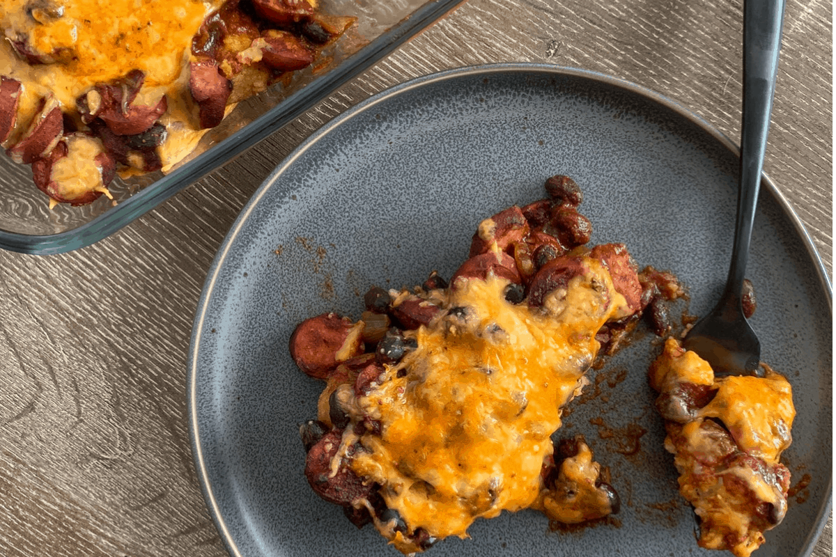 healthy chili dog tater tot casserole on a plate and the corner of the baking dish