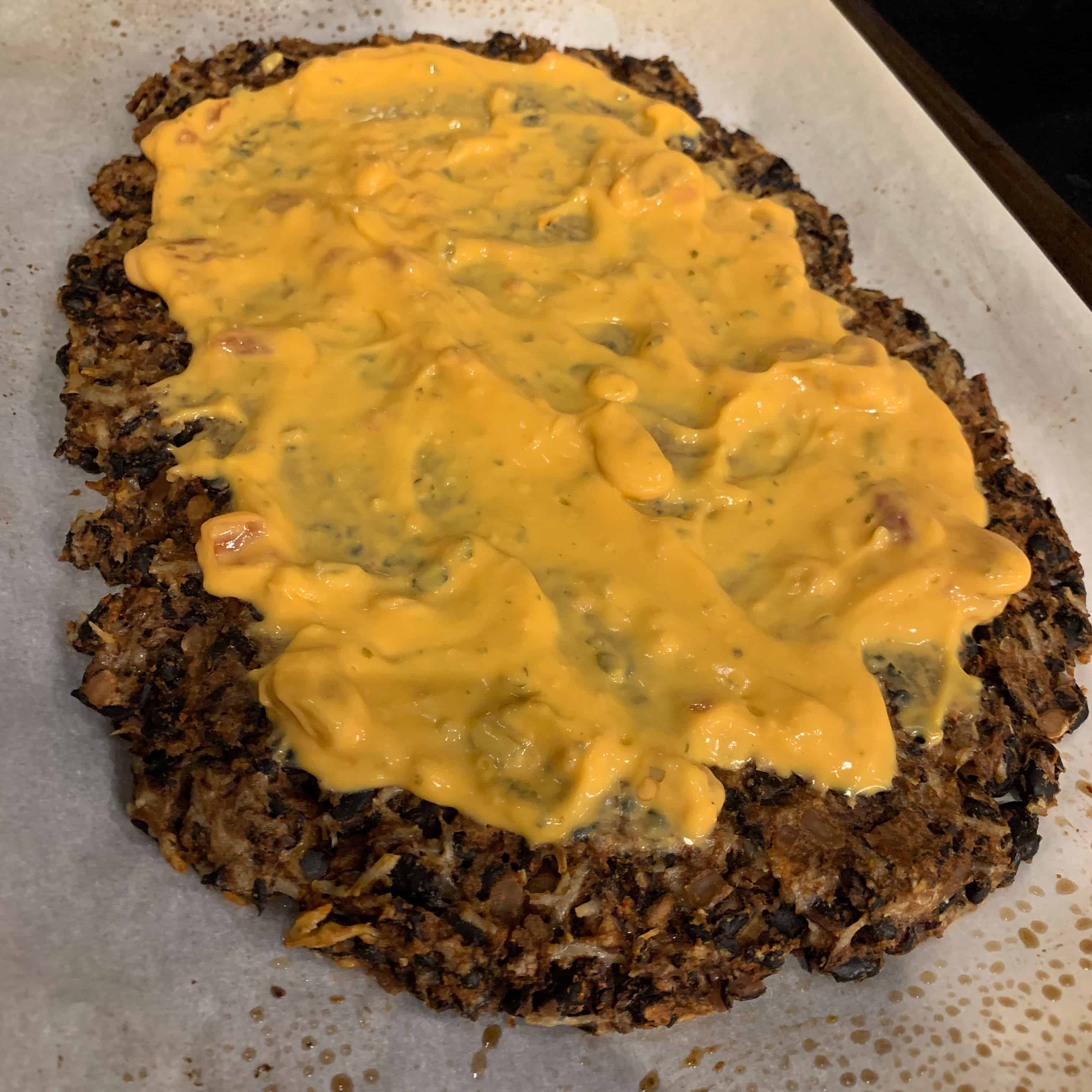 black bean pizza crust with queso on top