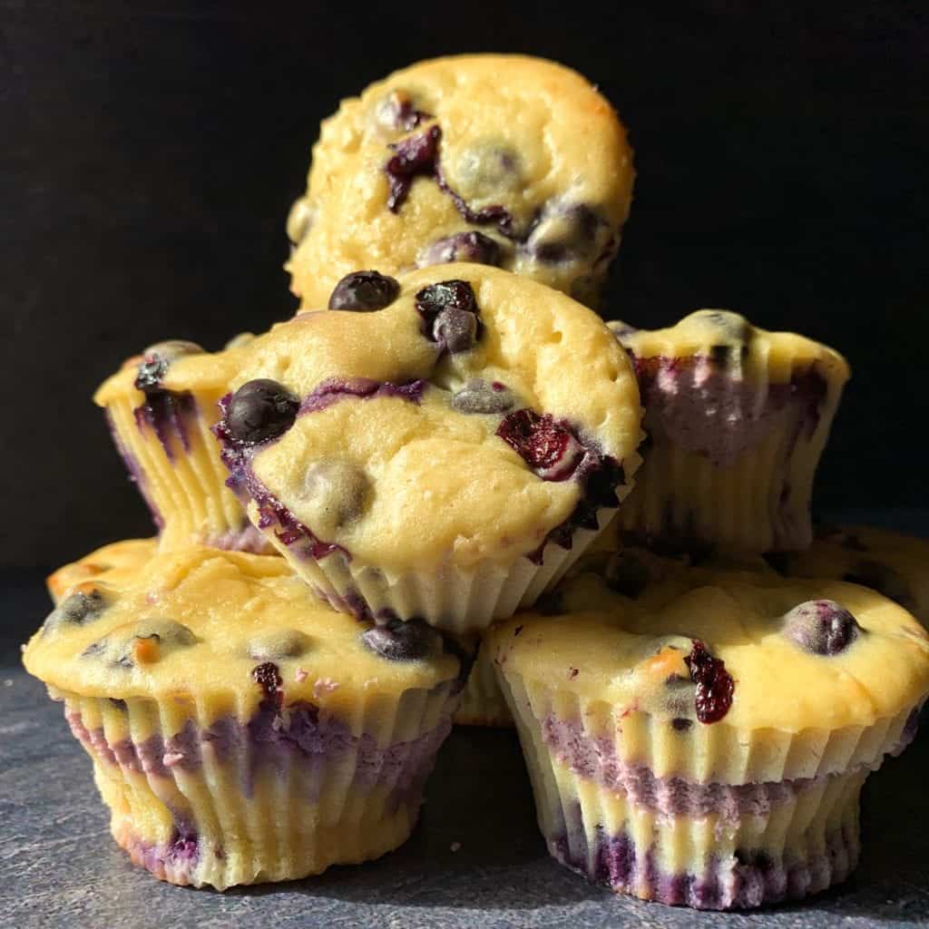 a pyramid of high protein blueberry cheesecake muffins