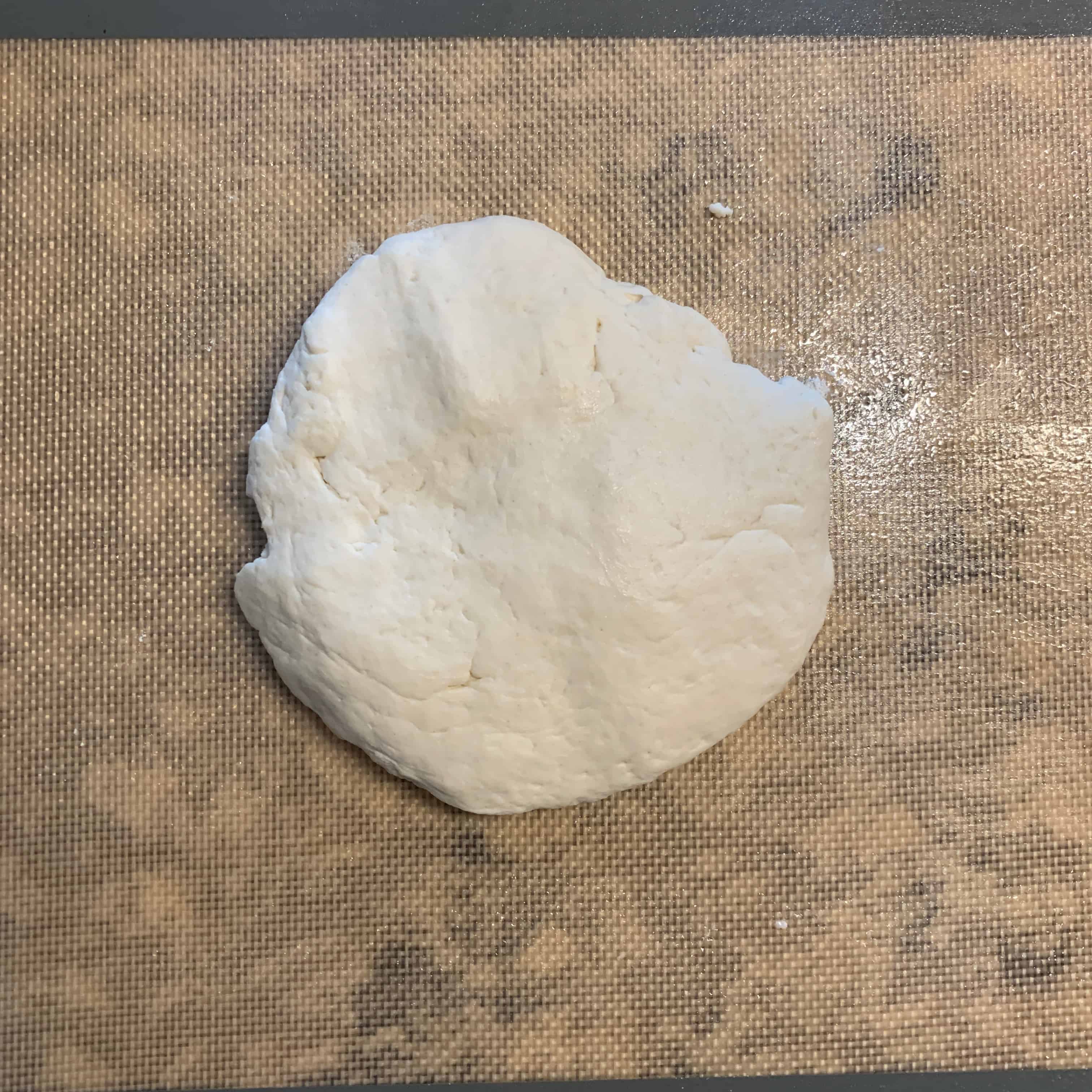 final pizza crust dough before rolling out