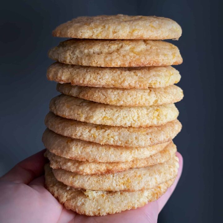 a stack of lemon protein cookies in a hand