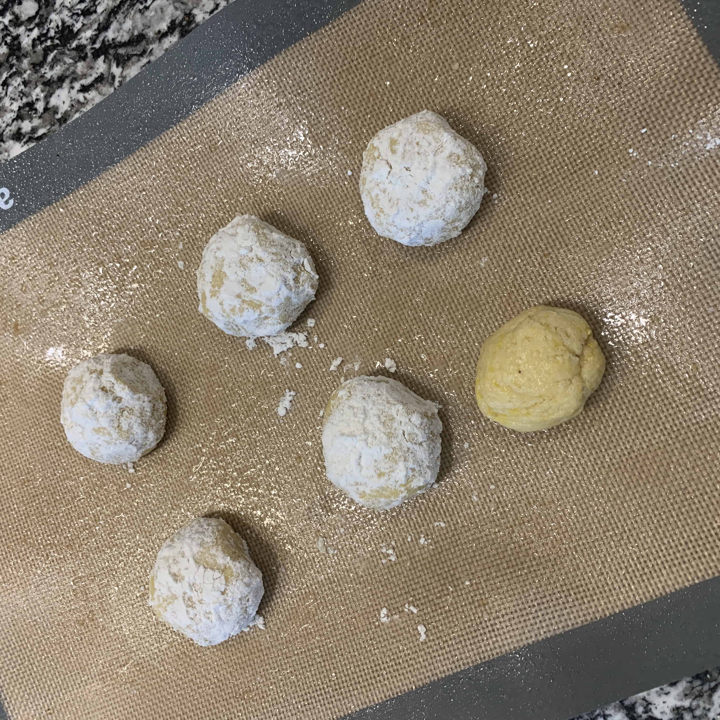 lemon protein cookies rolled into balls and rolled in powdered sugar