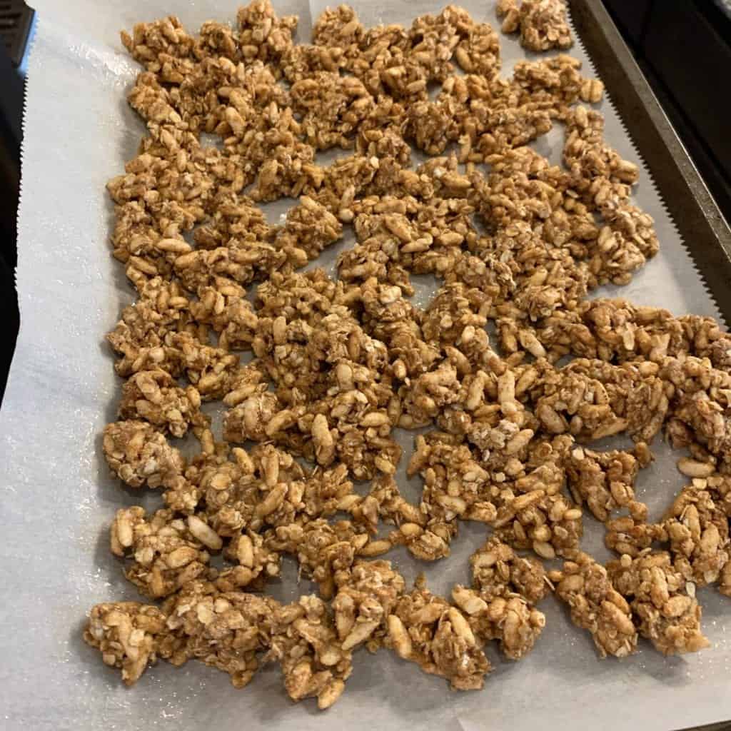 the protein granola on a baking sheet lined with parchment paper before baking