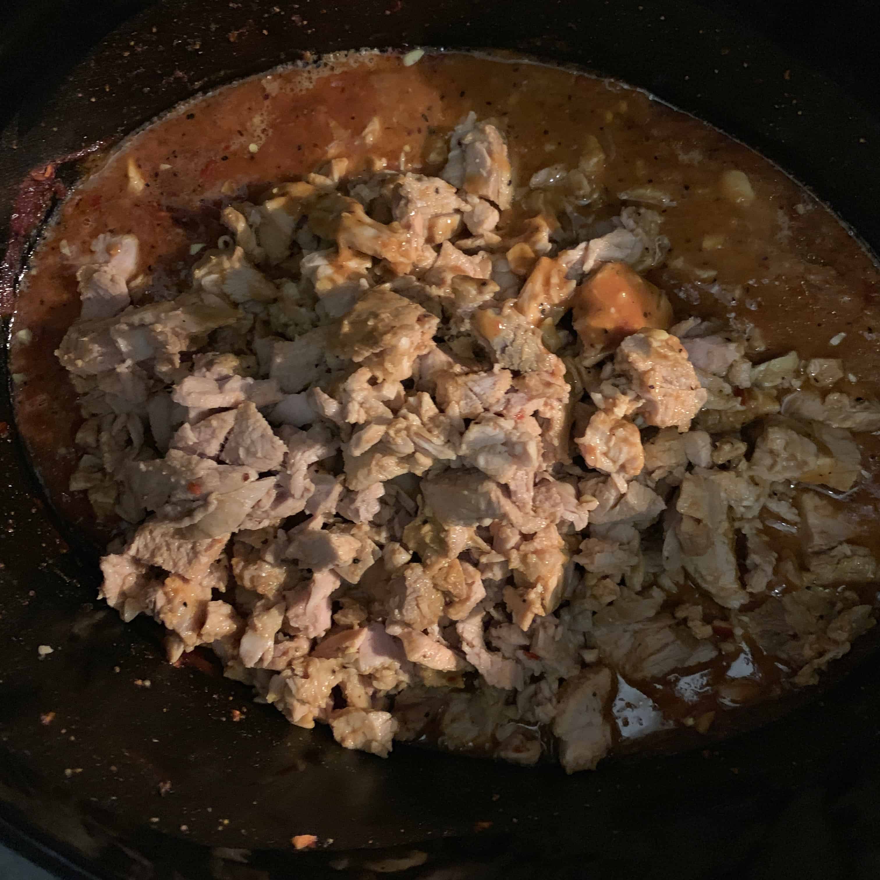 cooked pork in the crockpot after chopping