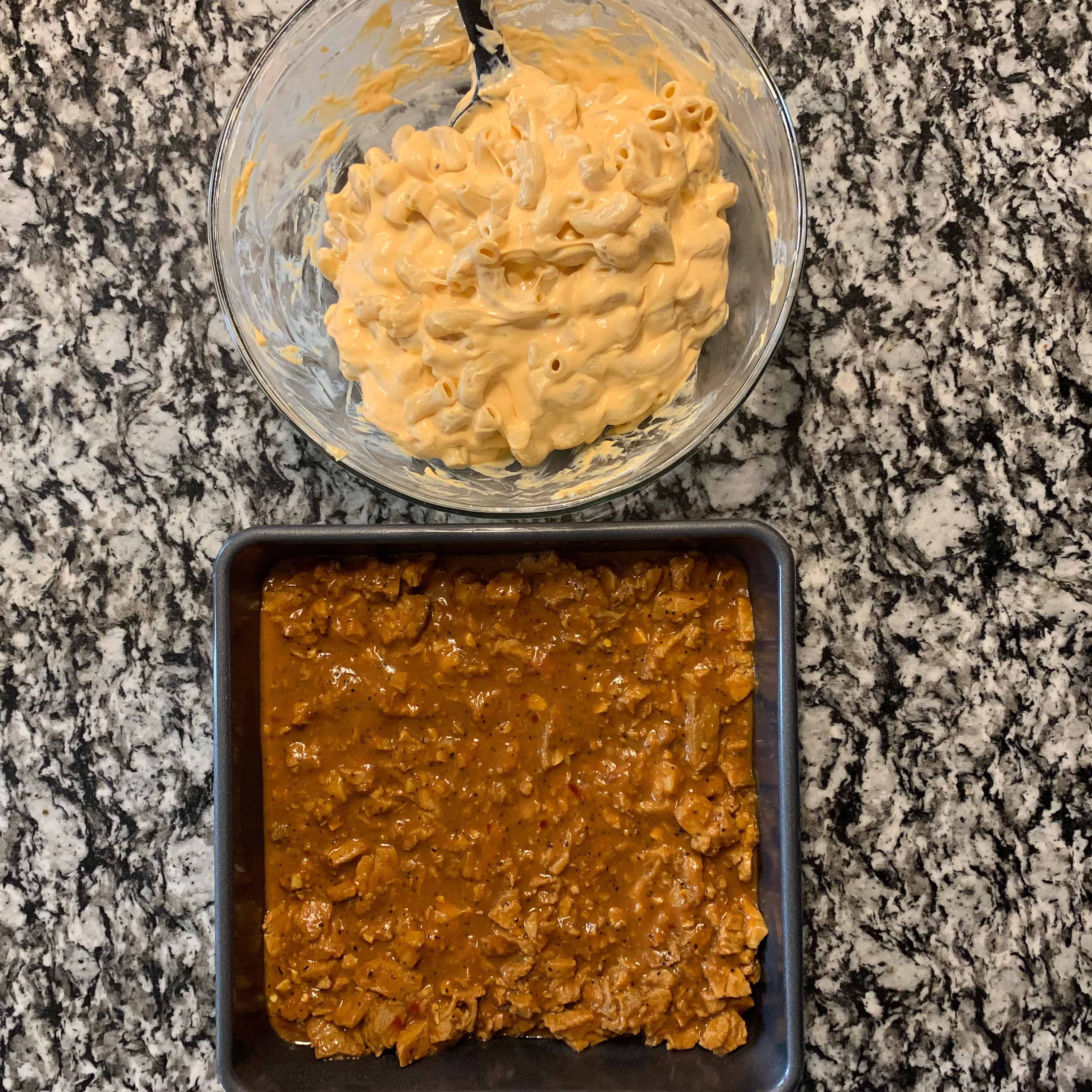 crockpot pork tenderloin in a baking dish with mac and cheese in a bowl beside it