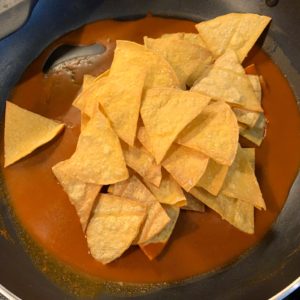 baked tortilla chips in enchilada sauce