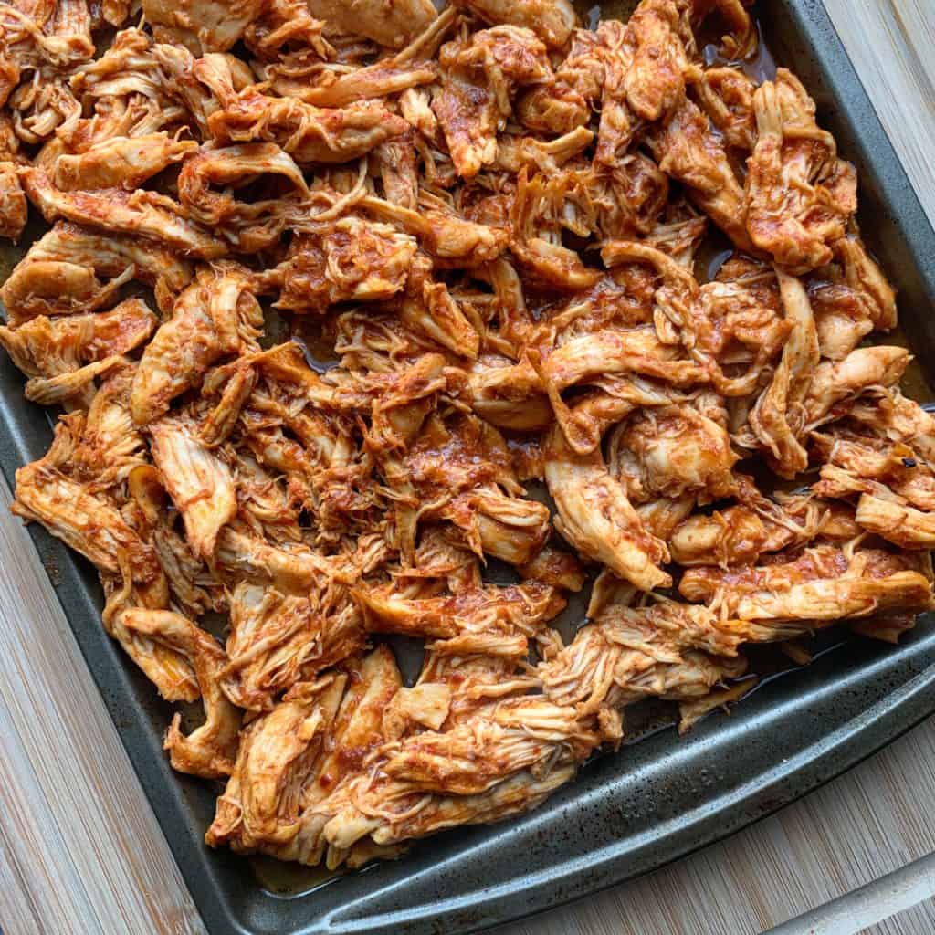 honey chipotle crockpot pulled chicken on a baking sheet