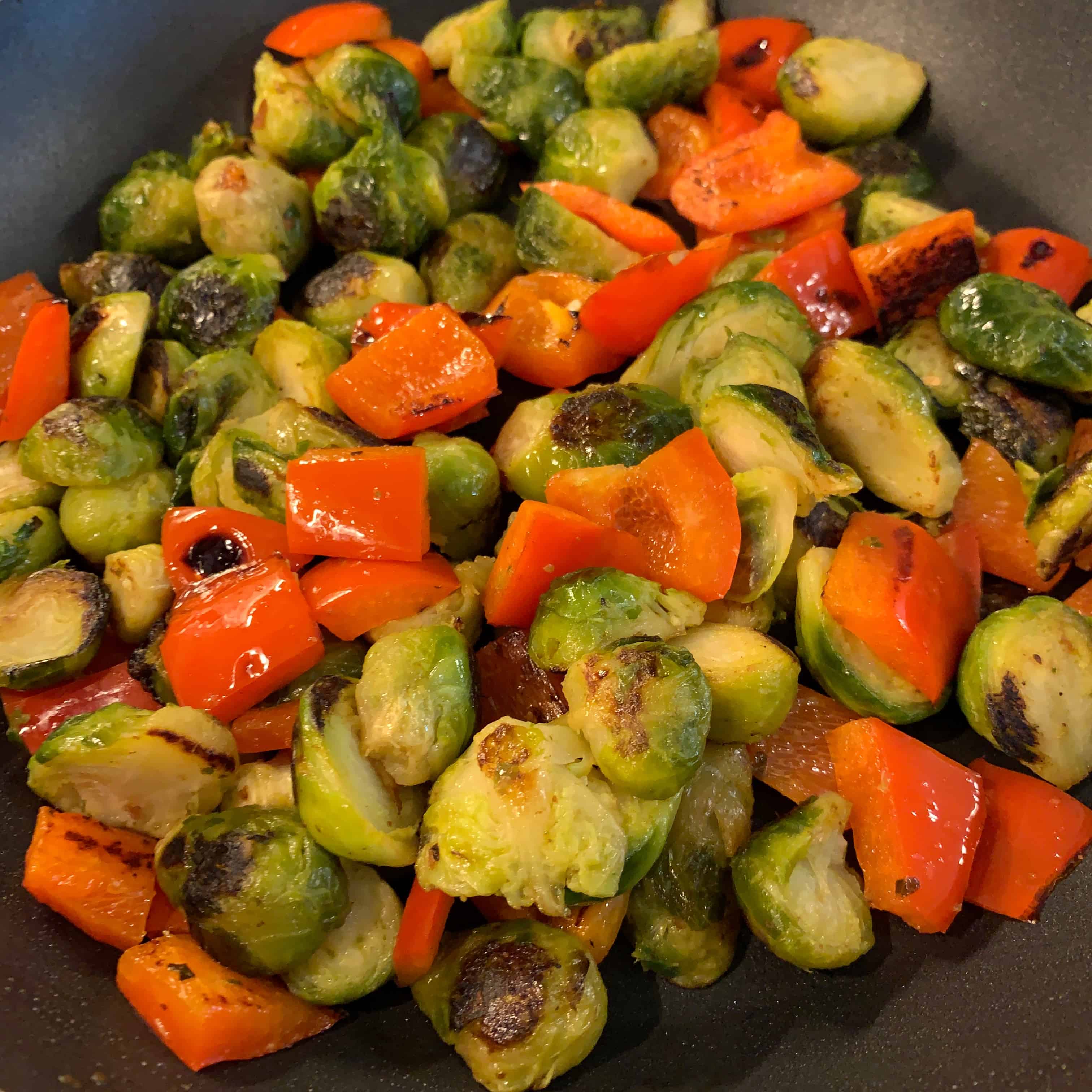 bell pepper and brussels sprouts in a skillet