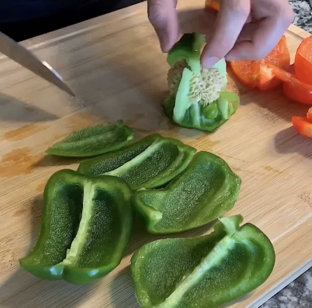 green bell pepper sliced on a cutting board
