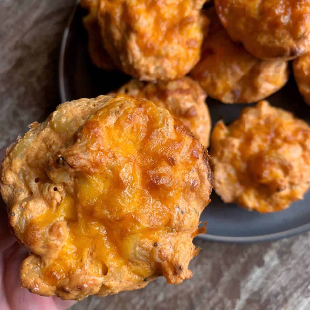 holding a mac and cheese muffin