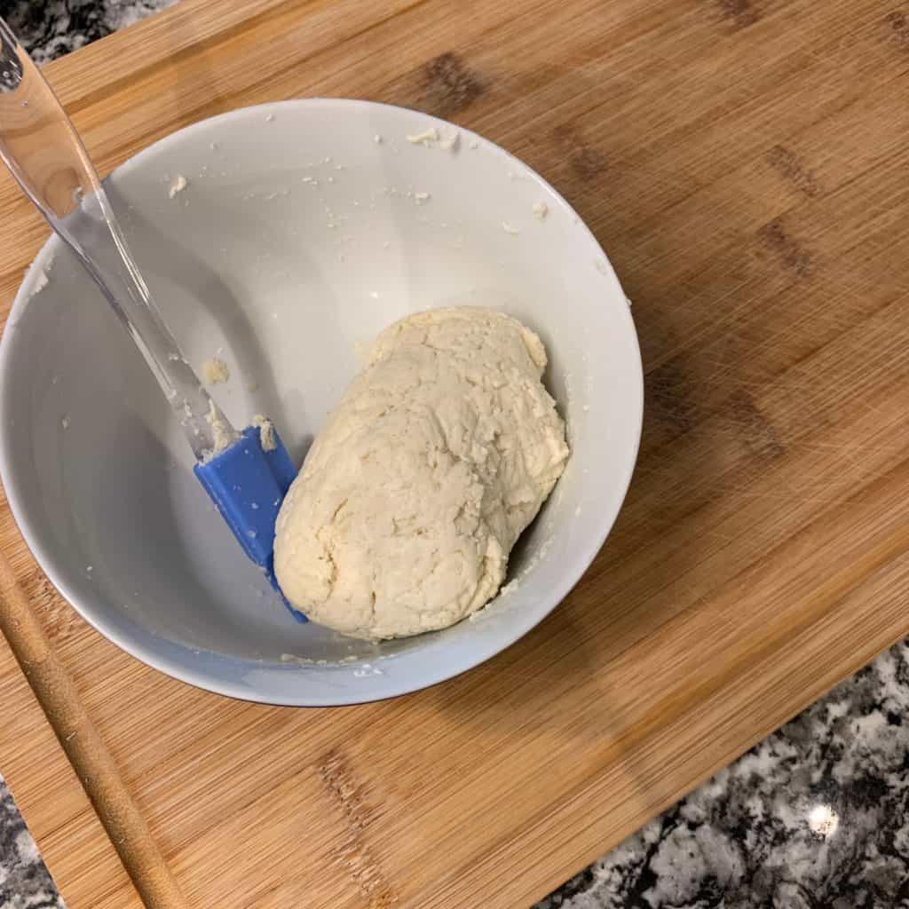 cinnamon roll dough ball in a bowl
