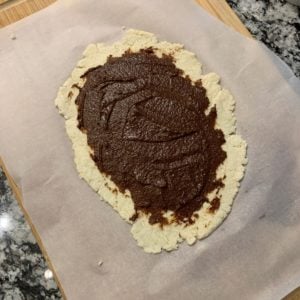 cinnamon sugar butter spread over the cinnamon roll dough