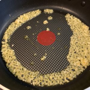 ginger and garlic in a pan with hot olive oil