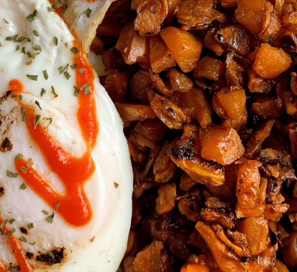 sweet potato hash browns with a fried egg and bacon