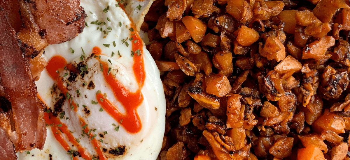 sweet potato hash browns with a fried egg and bacon