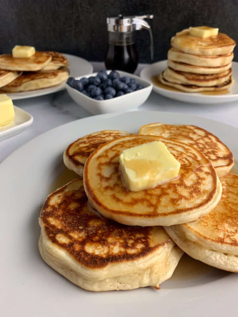 protein powder pancakes on a plate with butter and syrup