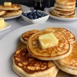 protein powder pancakes on a plate with butter and syrup
