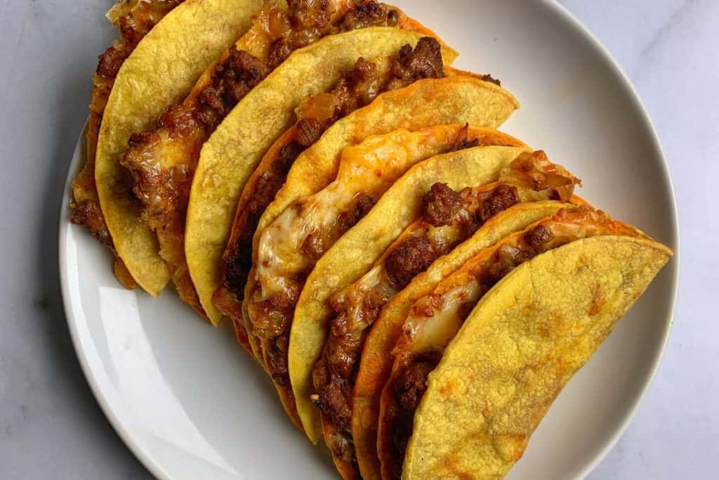 baked beef tacos on a white plate