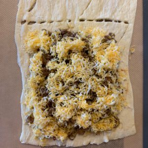 ground beef and cheese inside the crescent roll dough