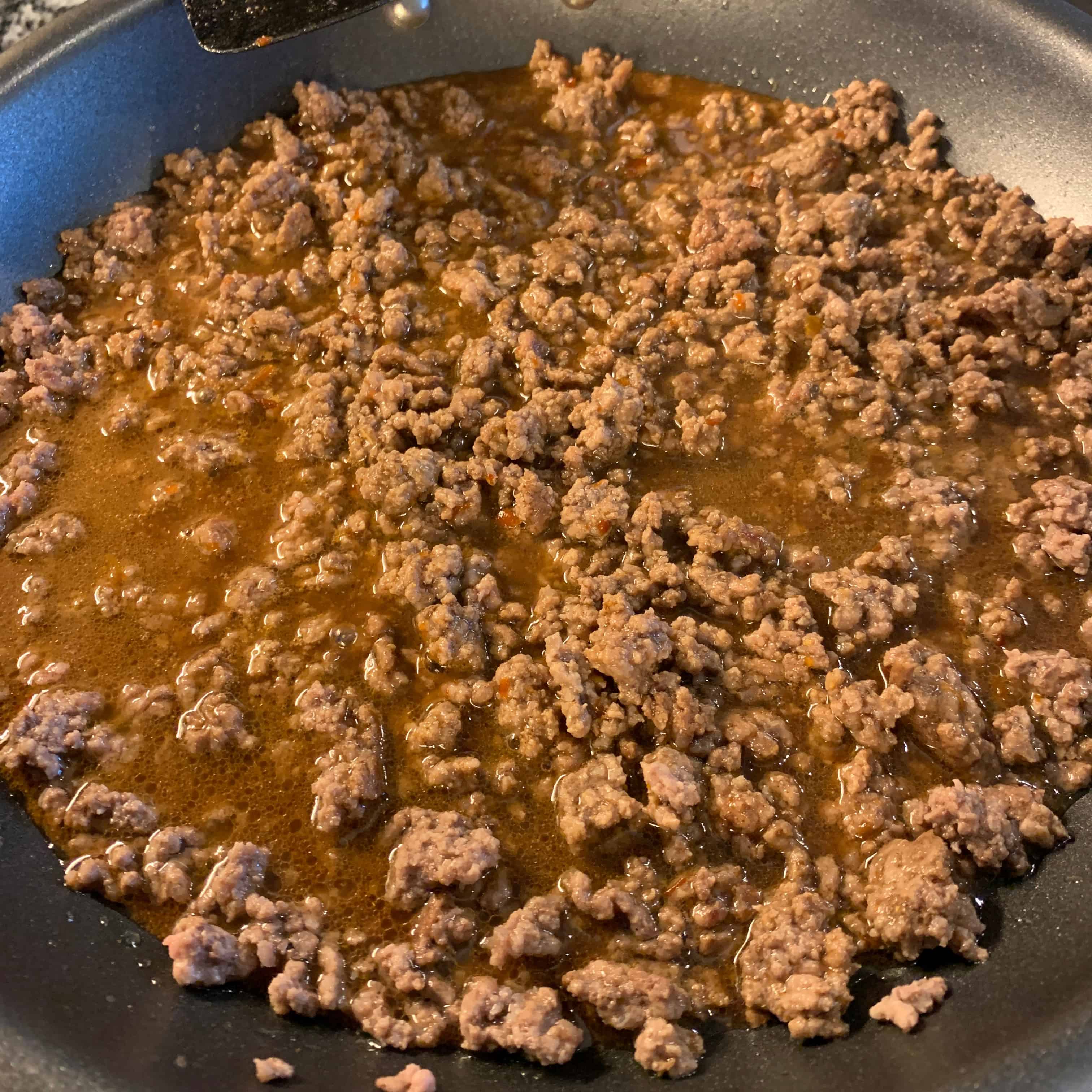 the five spice sauce for the ground beef stir fry in the pan cooking