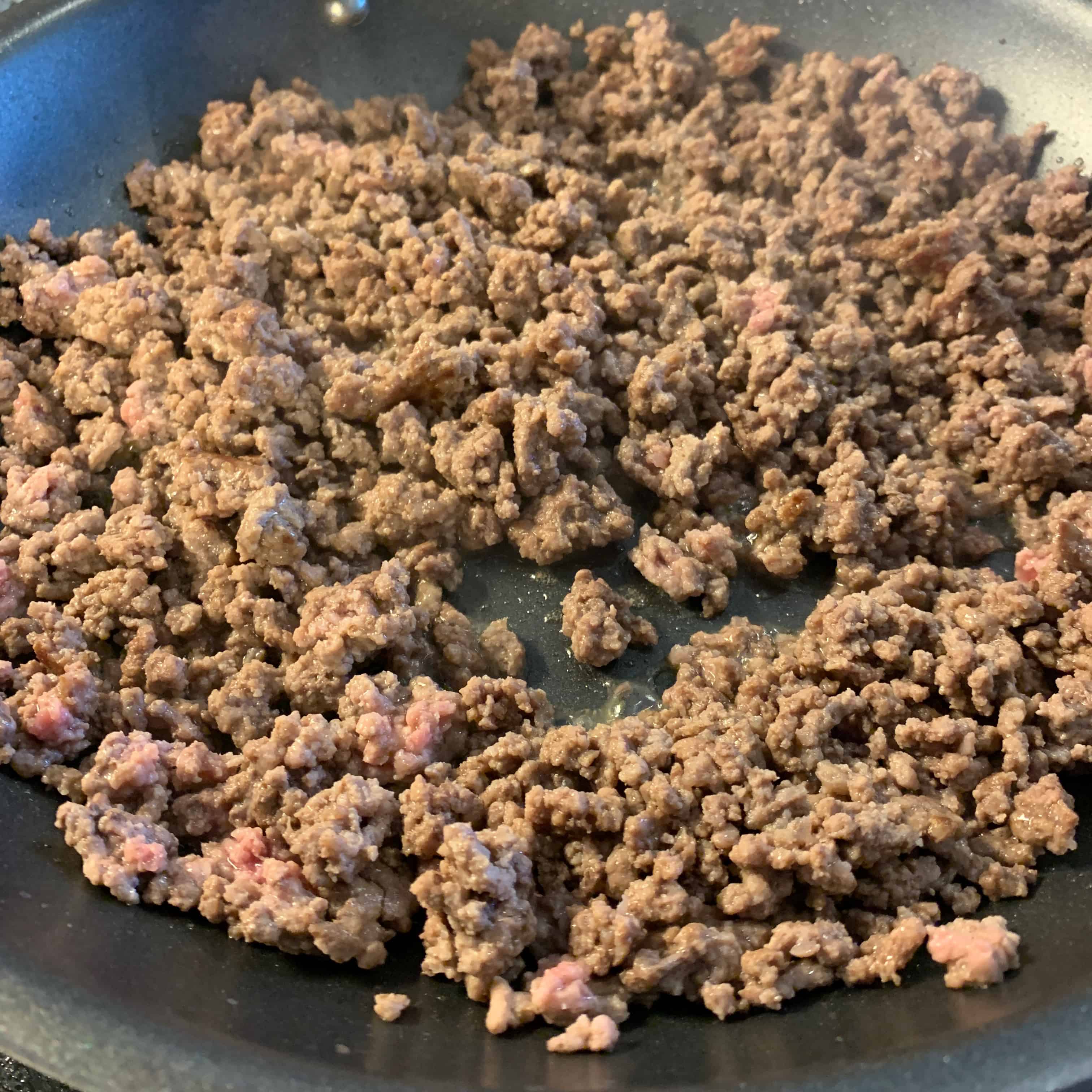 ground beef cooking in a large skillet
