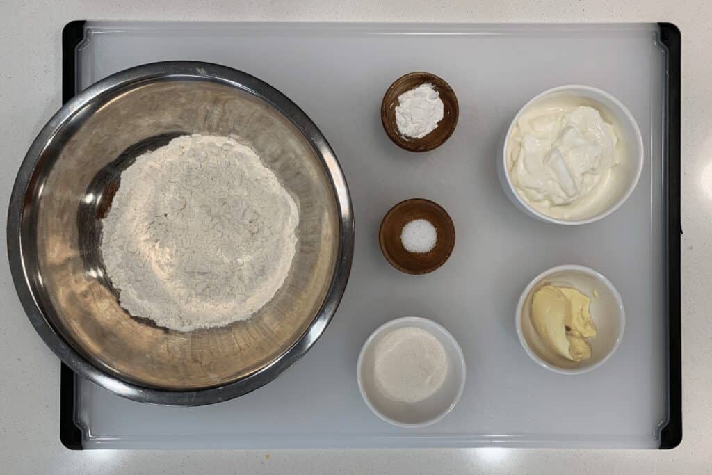 all purpose flour, baking powder, kosher salt, granulated sugar substitute, fat free Greek yogurt, and light butter in bowls