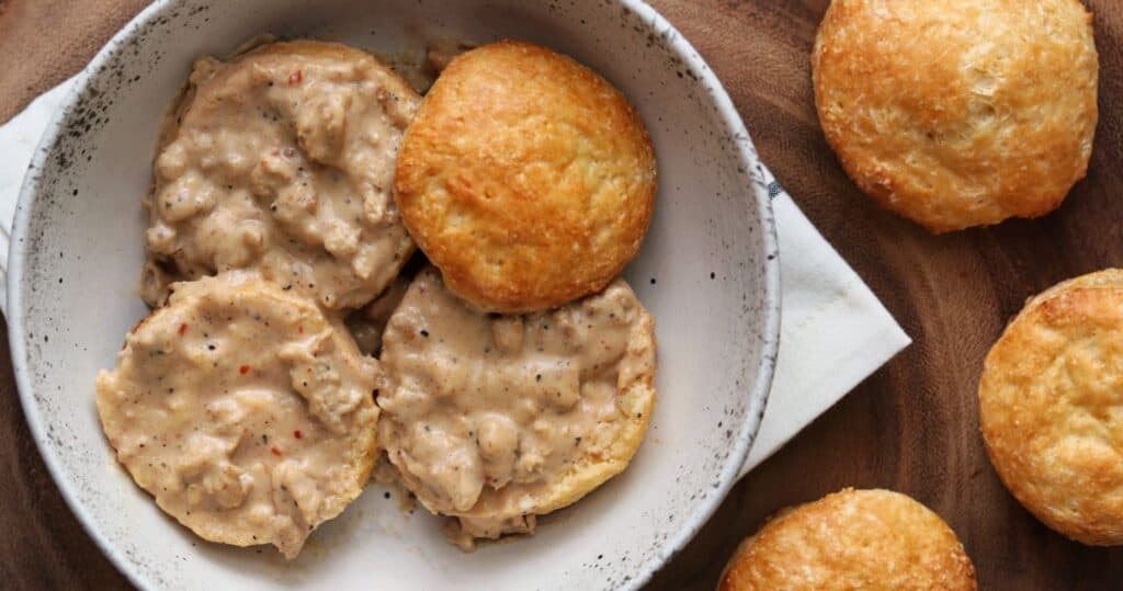 healthy sausage gravy on top of biscuits in a bowl