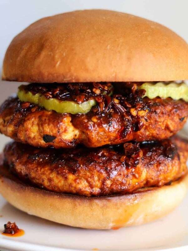 double spicy ground chicken burger with pickles and chili oil