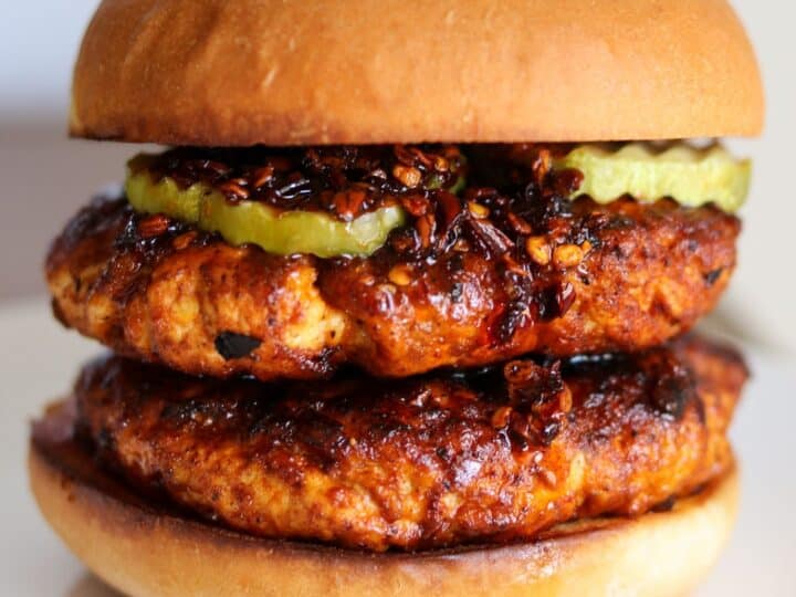 double spicy ground chicken burger with pickles and chili oil