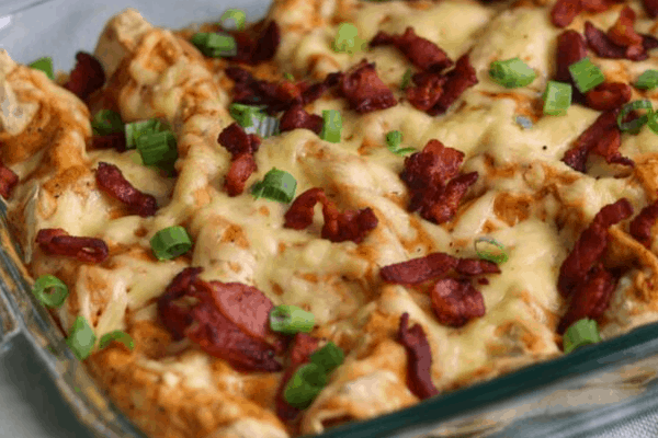 bacon gouda breakfast enchiladas in a glass baking dish