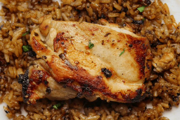 cilantro lime pan fried chicken thighs and rice on white plate