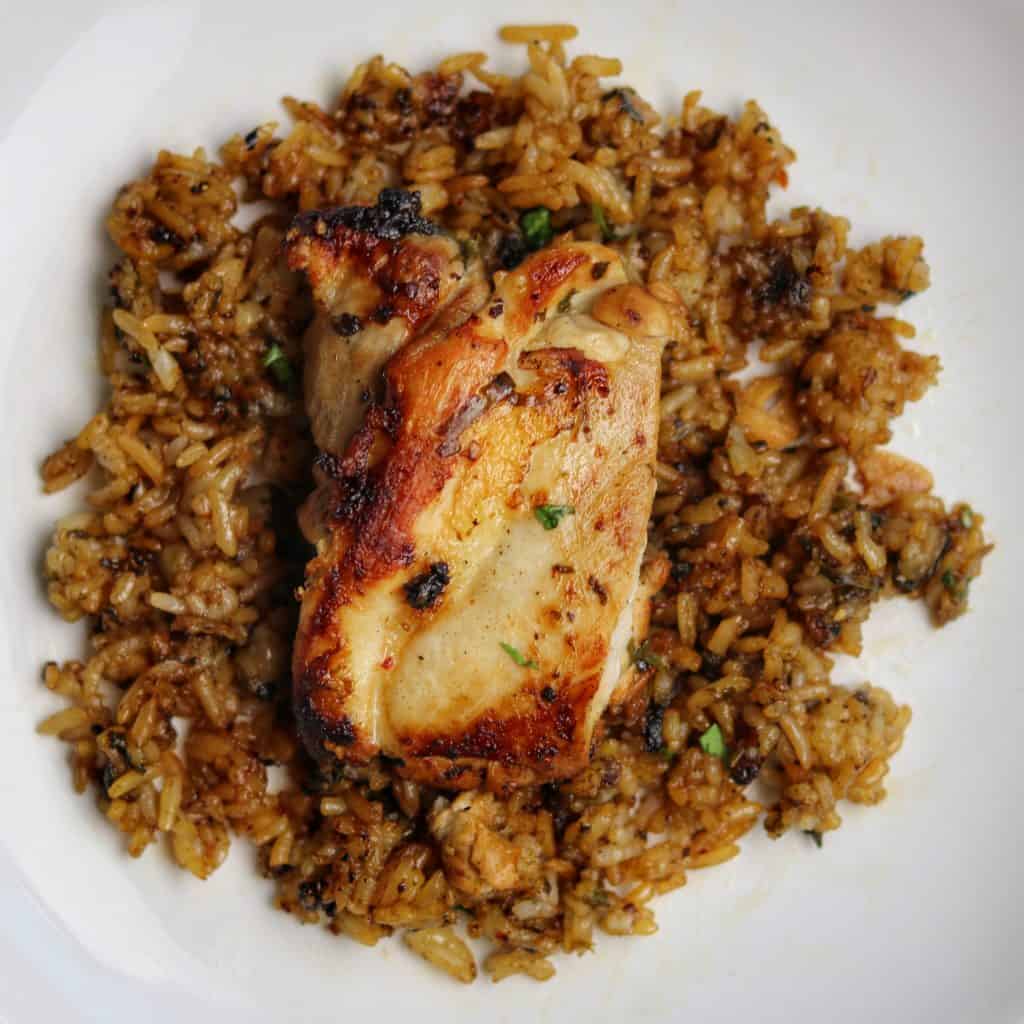 pan fried cilantro lime chicken thighs and rice on plate