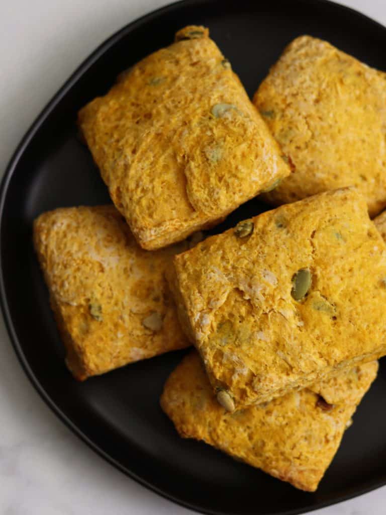 pumpkin biscuits on a black plate
