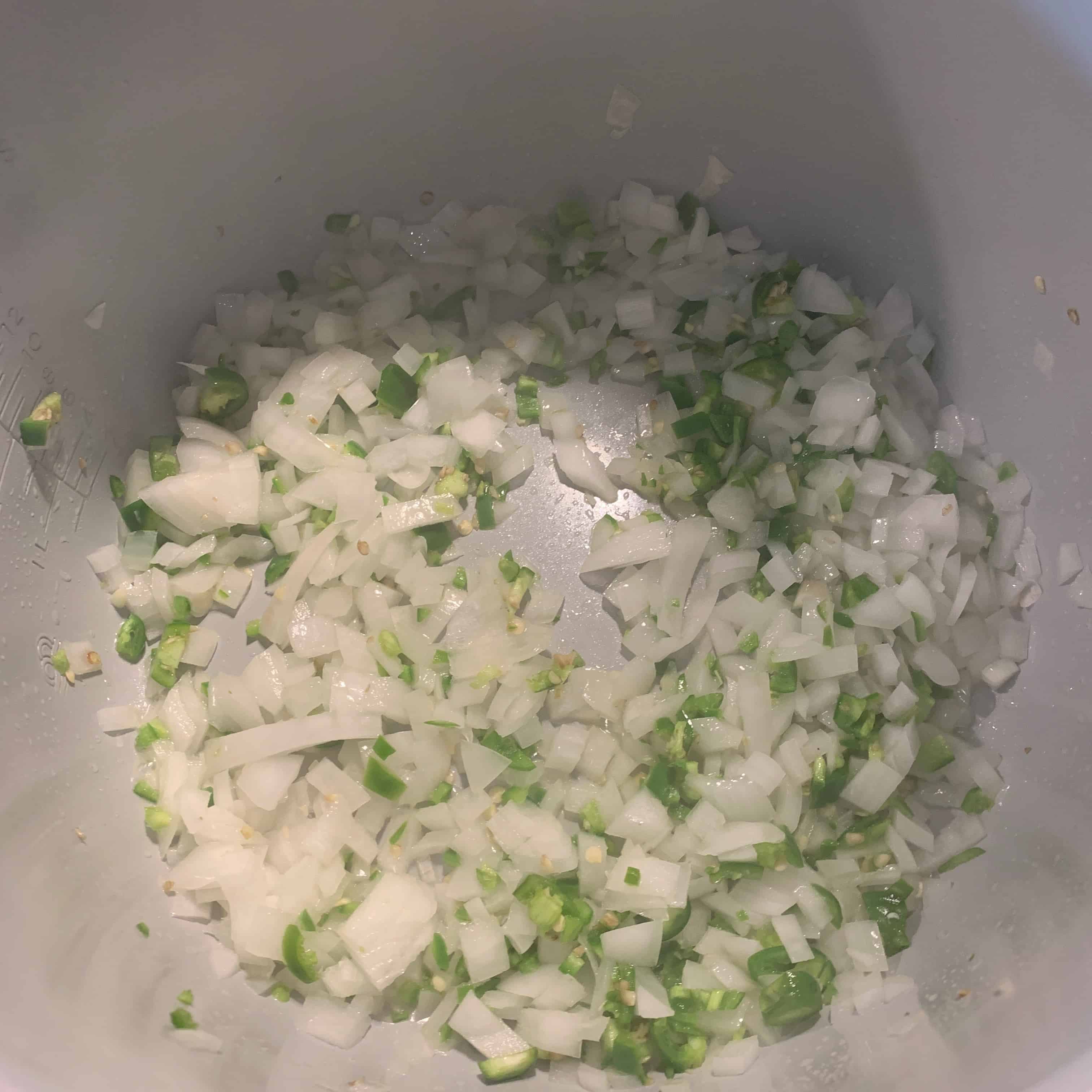 onions and serrano peppers in the pot