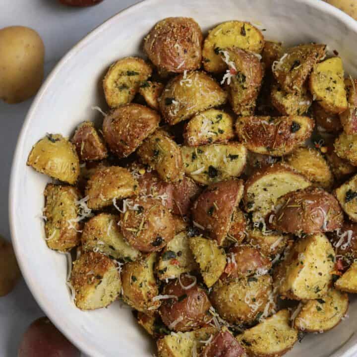 air fried rosemary parmesan potatoes in a white bowl