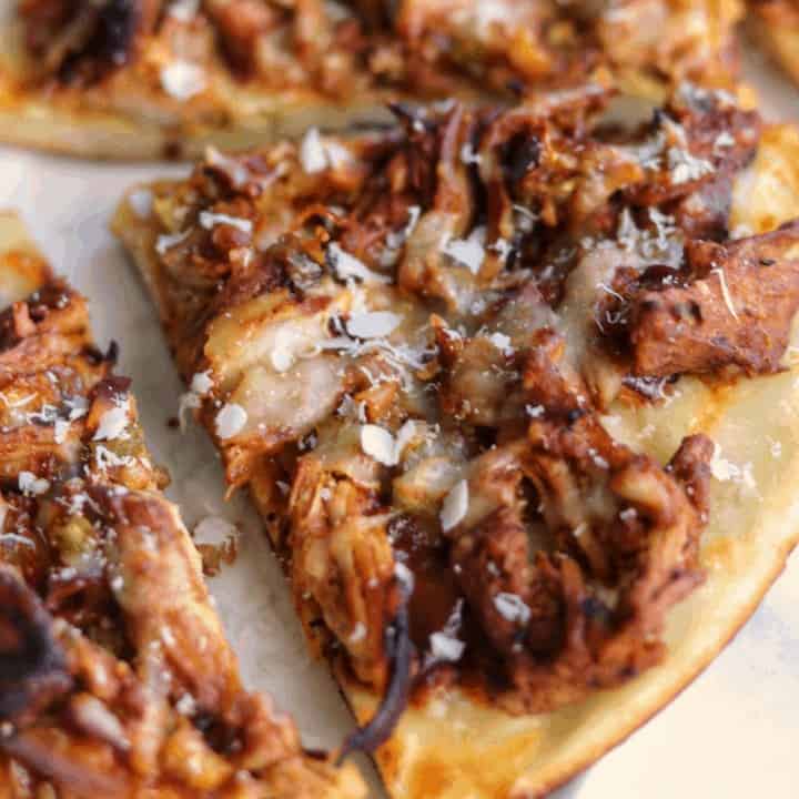 slice of pulled pork pizza on a white plate
