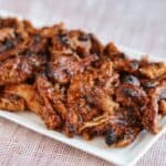 the crispy ninja foodi pulled pork on a white plate