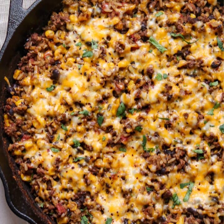 Mexican ground beef and rice casserole in a cast iron skillet