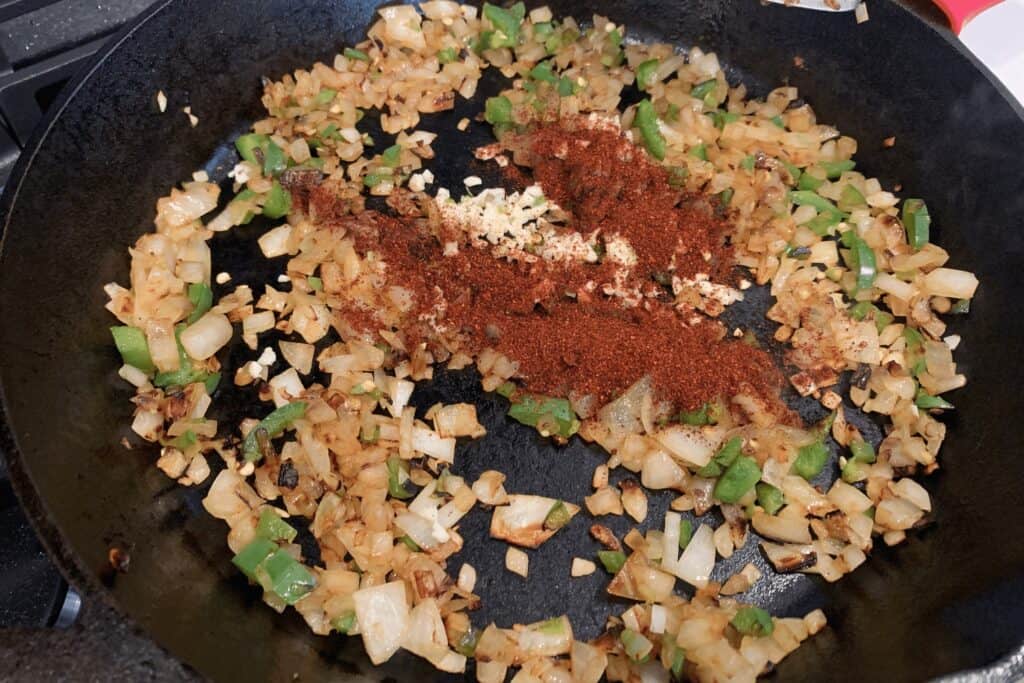 chili powder and minced garlic added to the softened onion and jalapeño