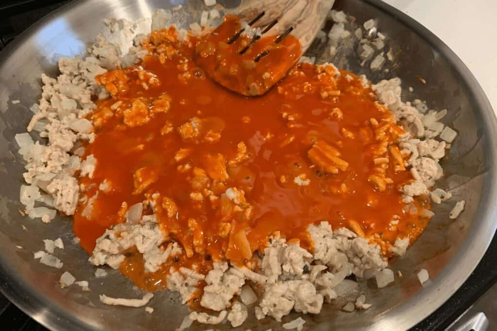 buffalo sauce added to the cooked ground chicken