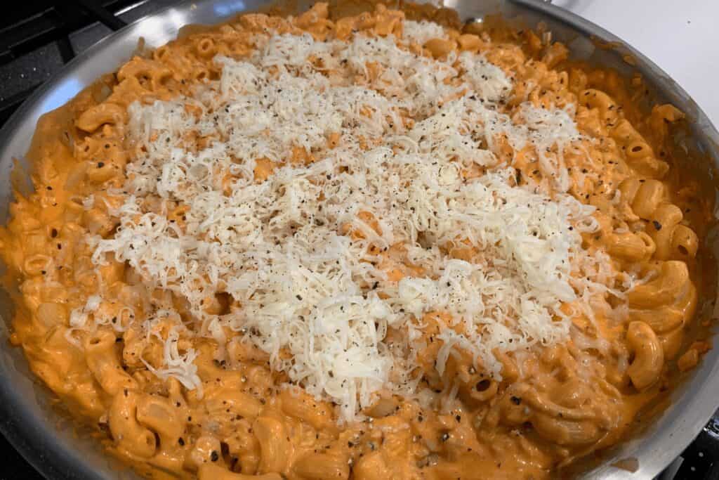 finely shredded monterey jack cheese on top of buffalo chicken mac and cheese