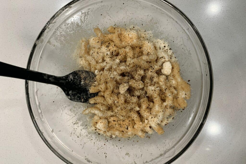 microwaved pasta coated in olive oil, grated parmesan, garlic powder, and black pepper