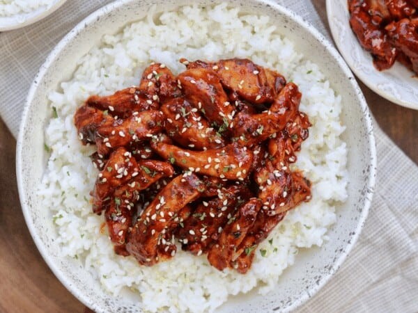 chili garlic pork tenderloin in a bowl with rice