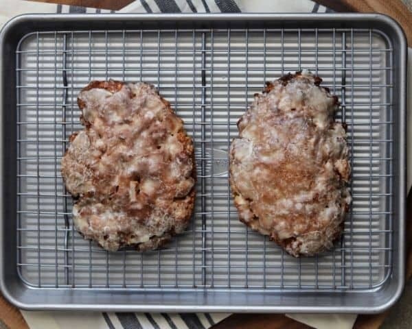 two air fried apple fritters on a wire rack