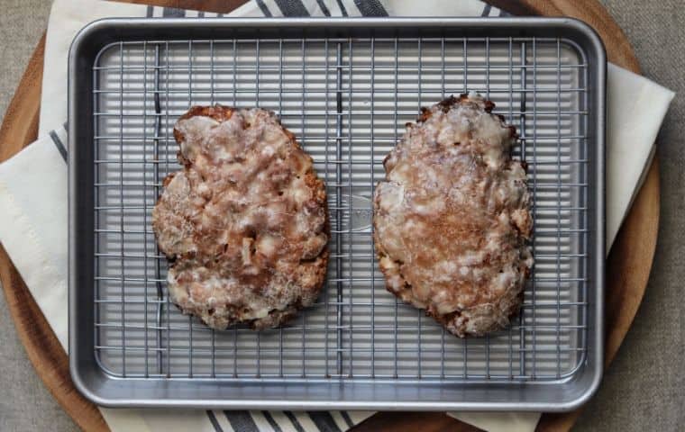 two air fried apple fritters on a wire rack