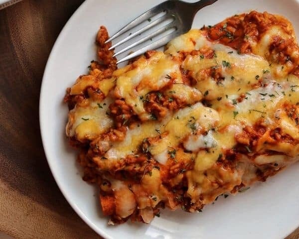 cheesy ground chicken and rice enchiladas on a plate