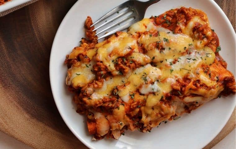 cheesy ground chicken and rice enchiladas on a plate