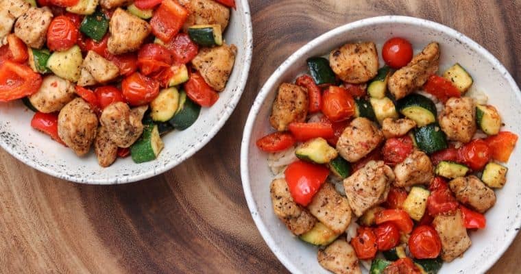 two bowls of cajun chicken and vegetables